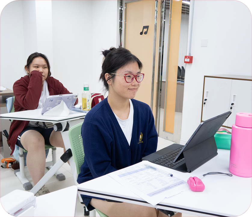 Students in uniform writing in class